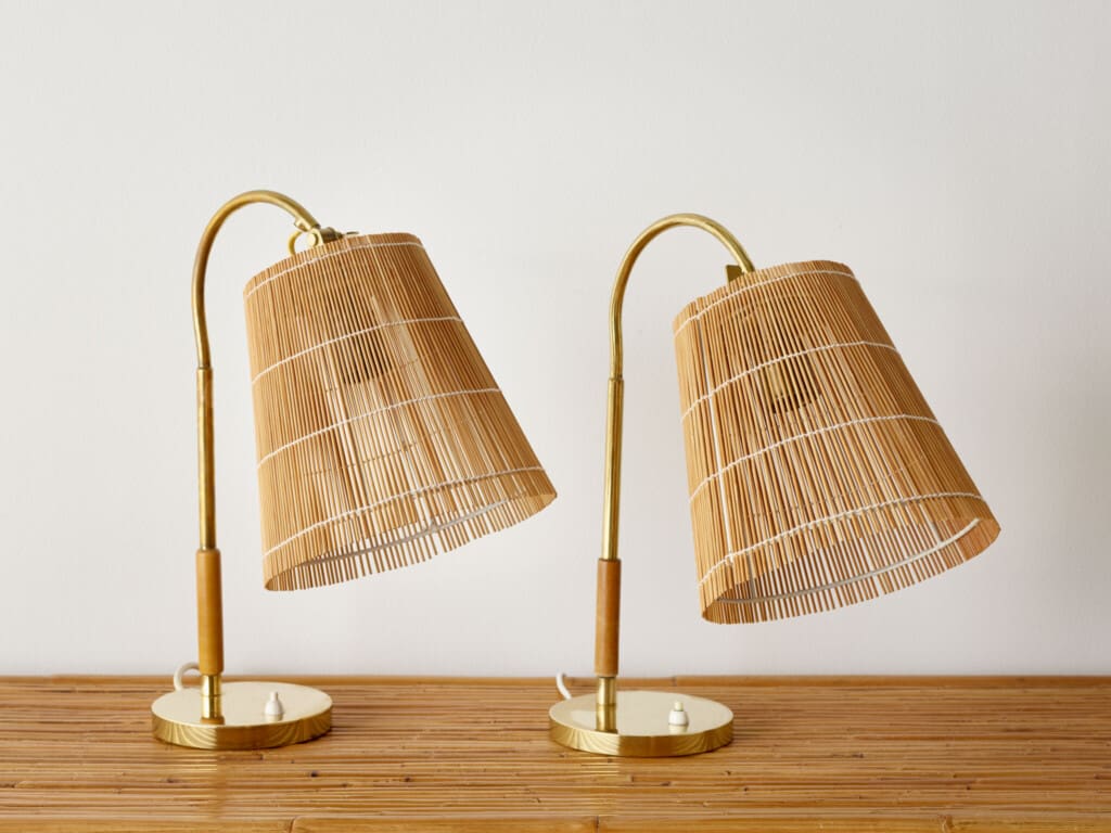 A pair of rattan cane and brass table lights by Paavo Tynell