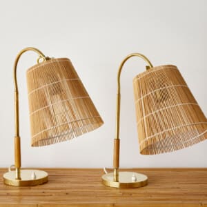 A pair of rattan cane and brass table lights by Paavo Tynell