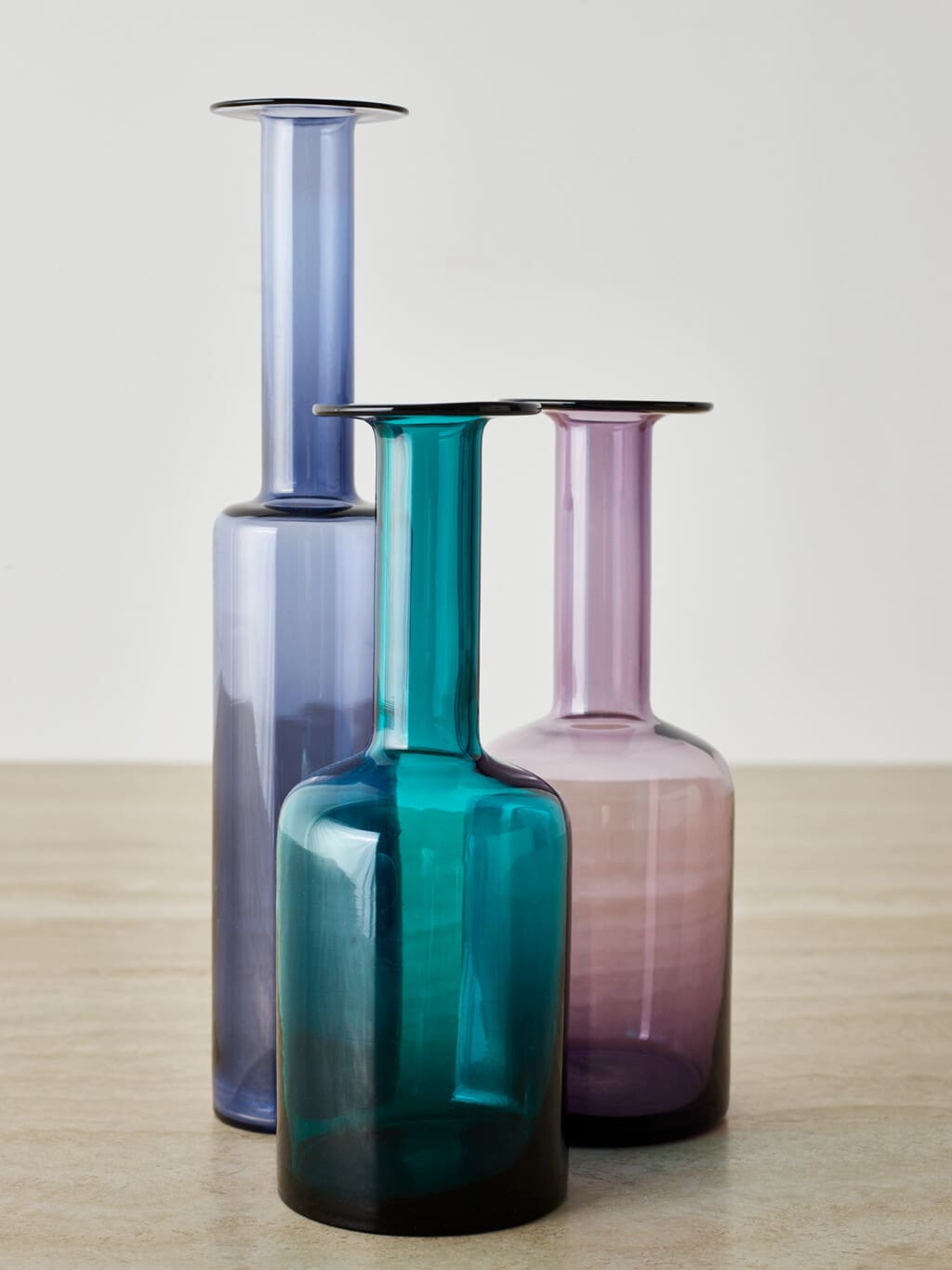 A group of three glass vases in playfull colours
