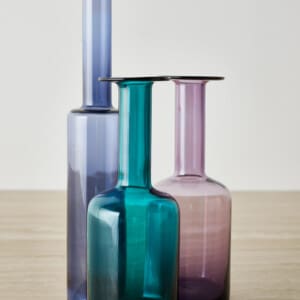 A group of three glass vases in playfull colours