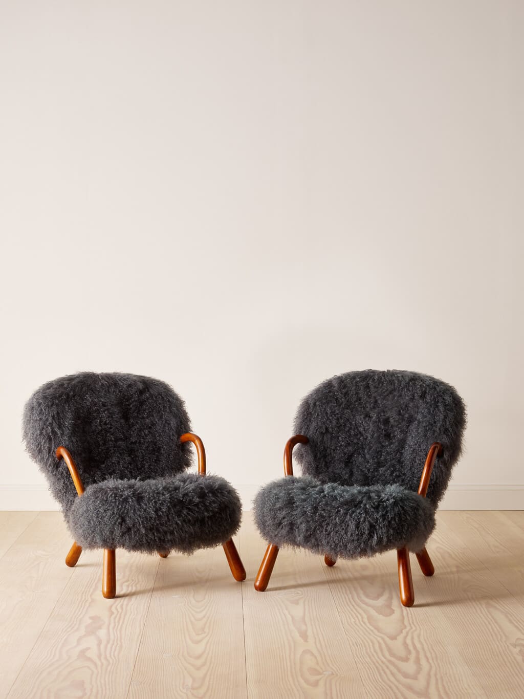 A pair of "Clam" chairs by Philip Arctander in grey long wool sheepskin
